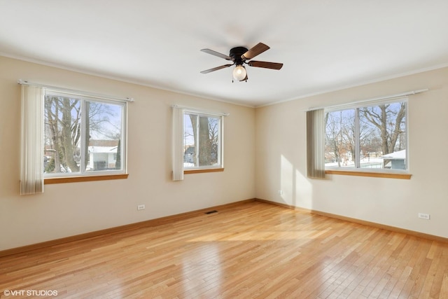 spare room with crown molding, ceiling fan, and light hardwood / wood-style floors