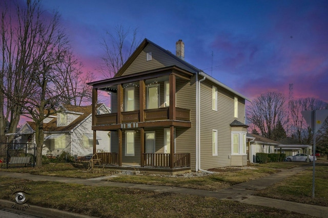 view of front of house with a balcony and covered porch