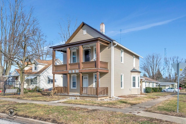 view of front property with a balcony and covered porch