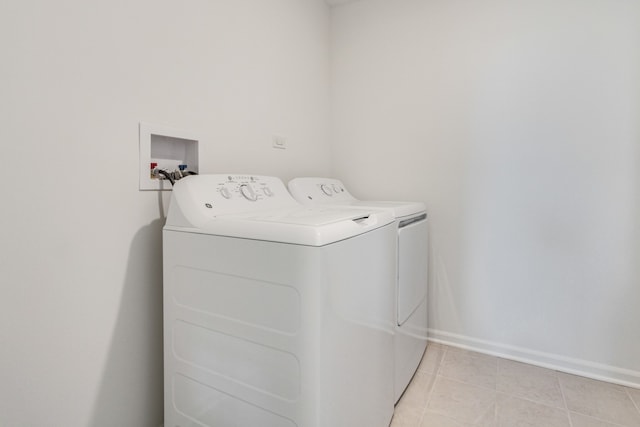 laundry area featuring light tile patterned floors and independent washer and dryer