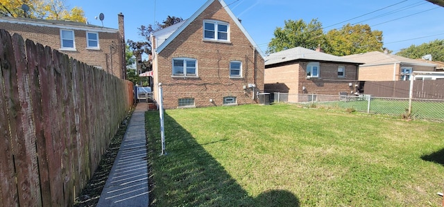 back of property featuring a yard and central AC unit