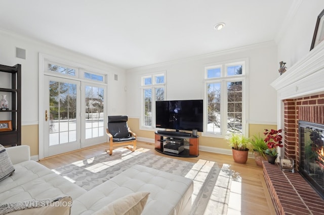 860 Gage Ln, Lake Forest, IL 60045 - living room featuring visible vents, crown molding, light wood-type flooring, a fireplace, and a wealth of natural light