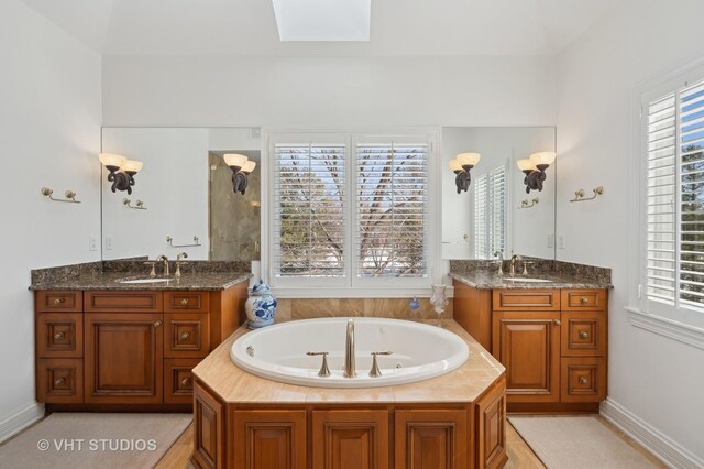 860 Gage Ln, Lake Forest, IL 60045 - bathroom with a skylight, plenty of natural light, two vanities, and a sink