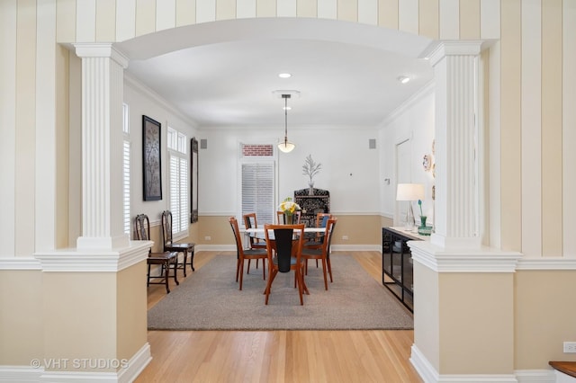 860 Gage Ln, Lake Forest, IL 60045 - dining area with ornate columns, crown molding, arched walkways, and light wood-style floors