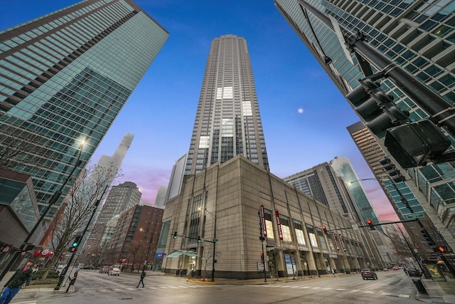 property at dusk featuring a view of city