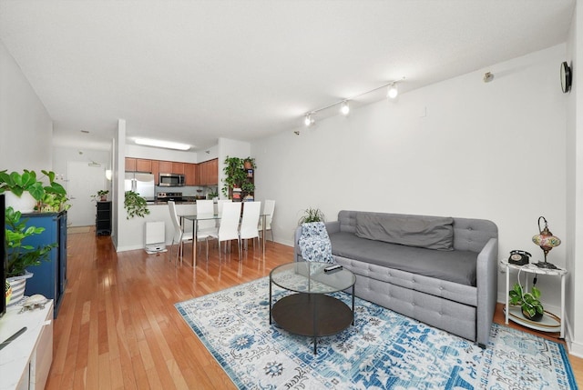 living room with light wood-type flooring and baseboards