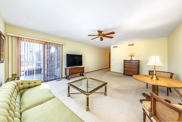 carpeted living room featuring ceiling fan