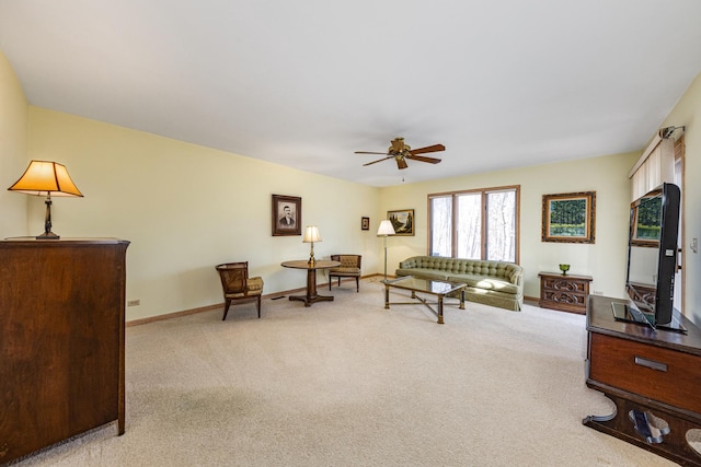 living room featuring light carpet and ceiling fan