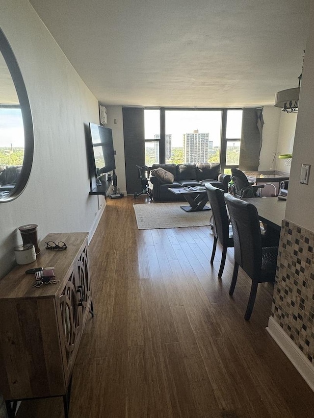 dining space featuring expansive windows and hardwood / wood-style floors