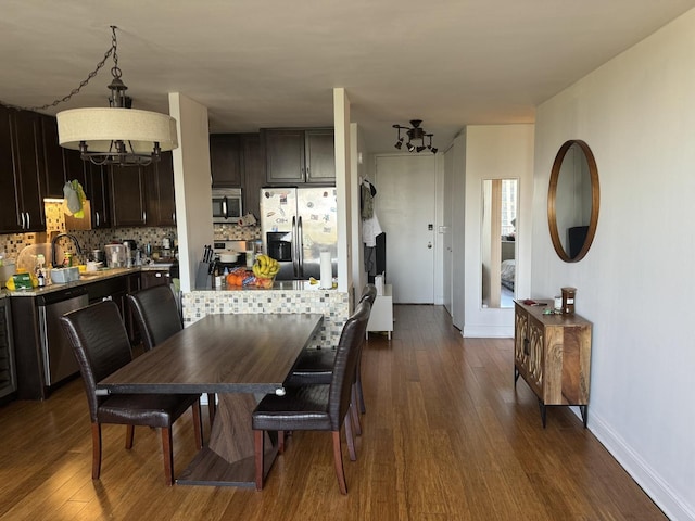 dining room with dark hardwood / wood-style flooring and sink