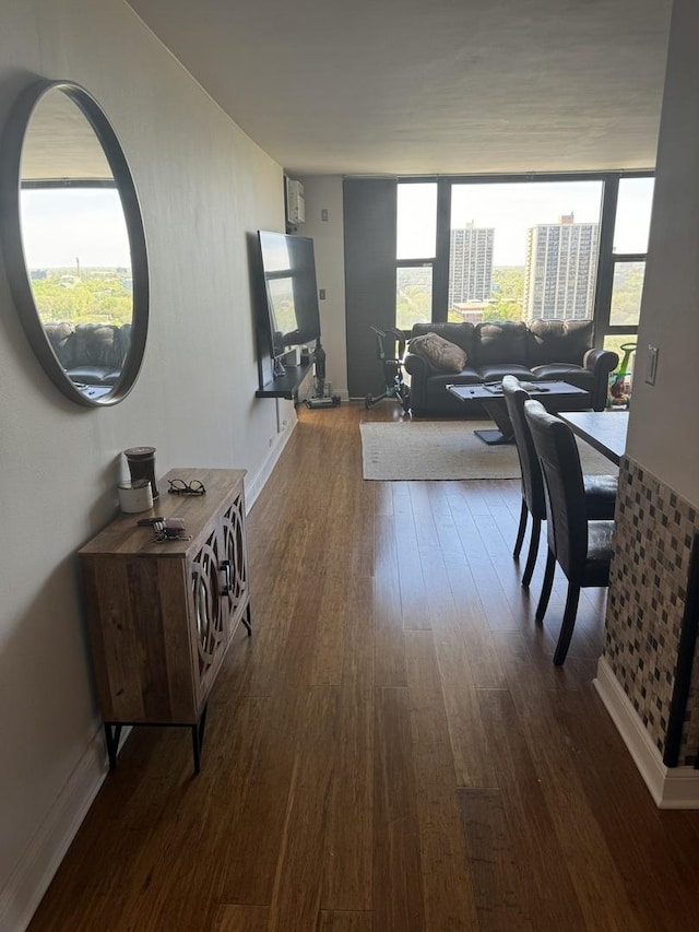 interior space with hardwood / wood-style flooring, floor to ceiling windows, and a wealth of natural light