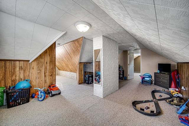 bonus room with wooden walls, vaulted ceiling, and carpet