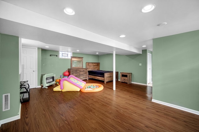 interior space featuring heating unit and dark hardwood / wood-style floors