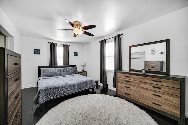 bedroom with dark wood-type flooring, ceiling fan, and multiple windows