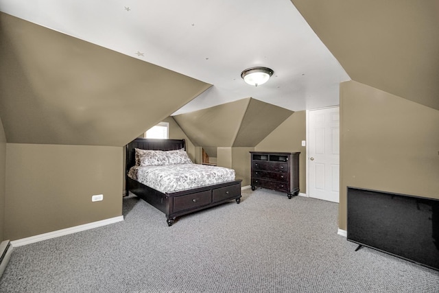 carpeted bedroom with a baseboard radiator and vaulted ceiling