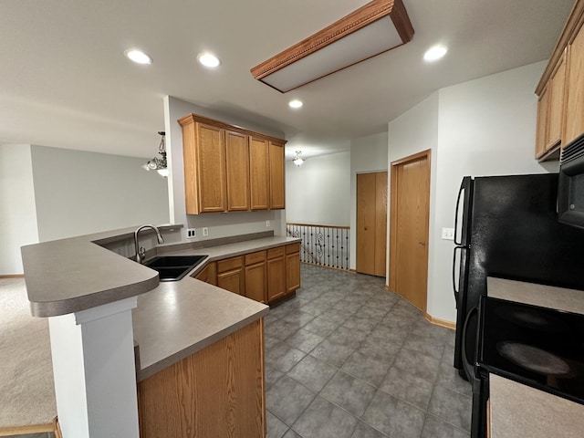 kitchen with pendant lighting, recessed lighting, a sink, range with electric cooktop, and a peninsula