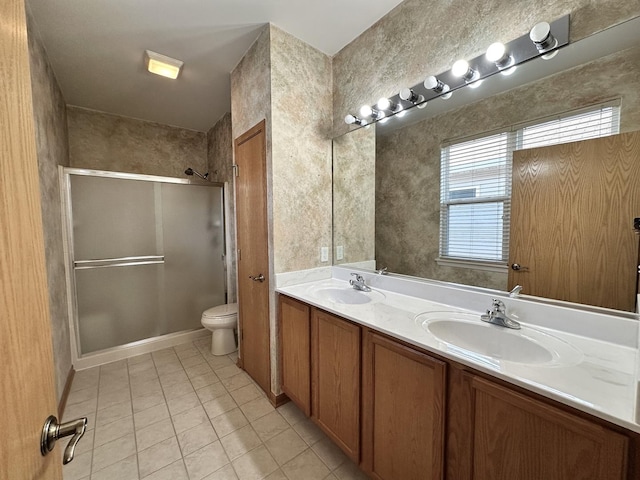 full bath featuring toilet, tile patterned flooring, an enclosed shower, and a sink