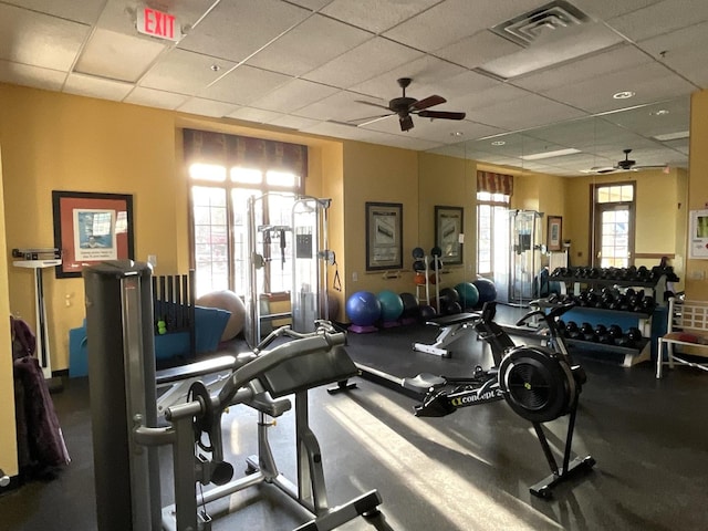 workout area featuring a paneled ceiling, visible vents, and a ceiling fan