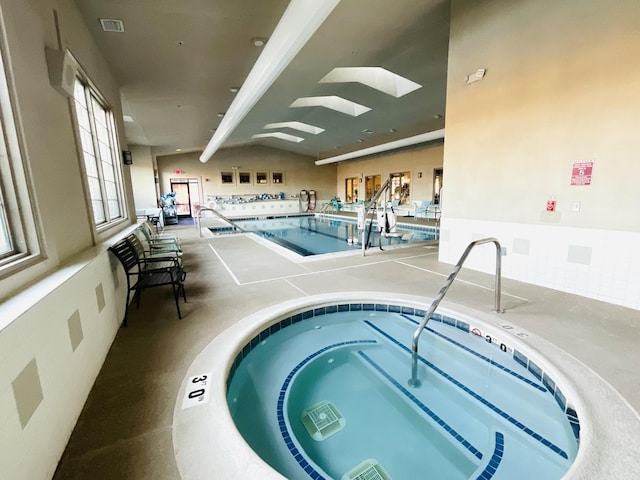 view of swimming pool featuring an indoor hot tub