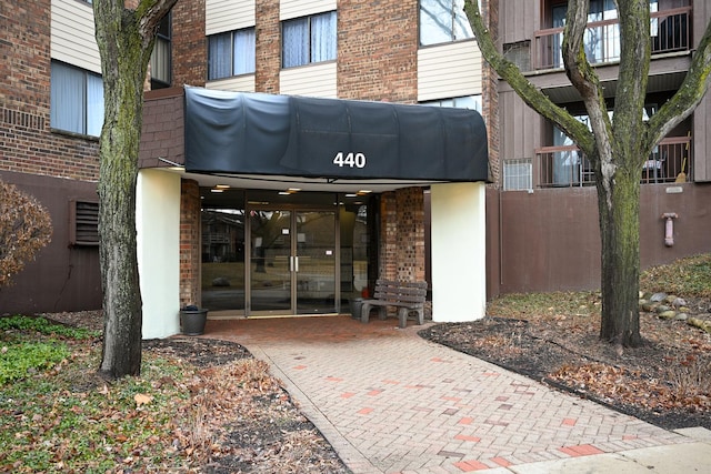 property entrance featuring brick siding