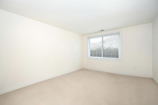 unfurnished room with visible vents and baseboards