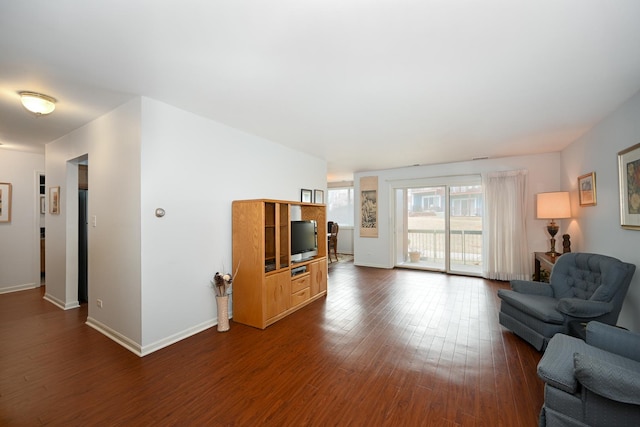 living area with dark wood-style floors and baseboards