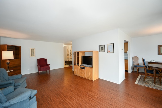 living room featuring dark wood-style flooring and baseboards