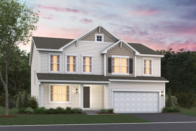 view of front of home featuring a yard and a garage