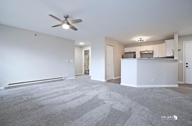 unfurnished living room with dark carpet, a baseboard radiator, and ceiling fan