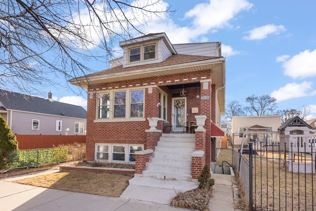 bungalow-style house with brick siding and fence