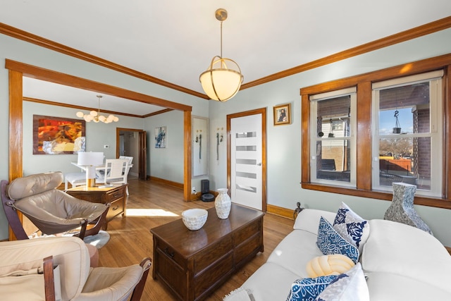 living area featuring ornamental molding, wood finished floors, and baseboards