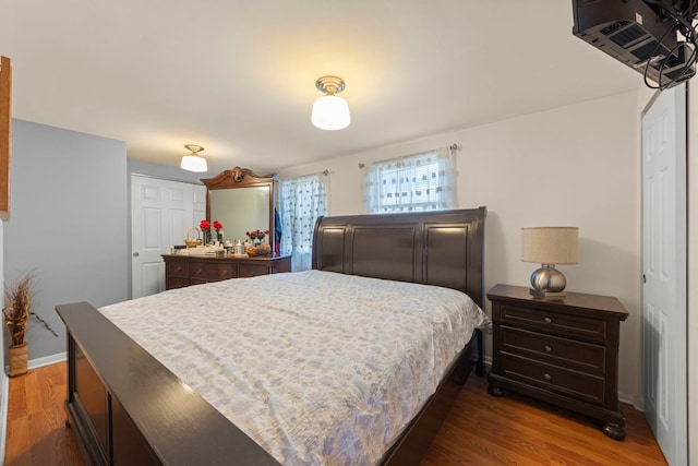 bedroom featuring baseboards and wood finished floors