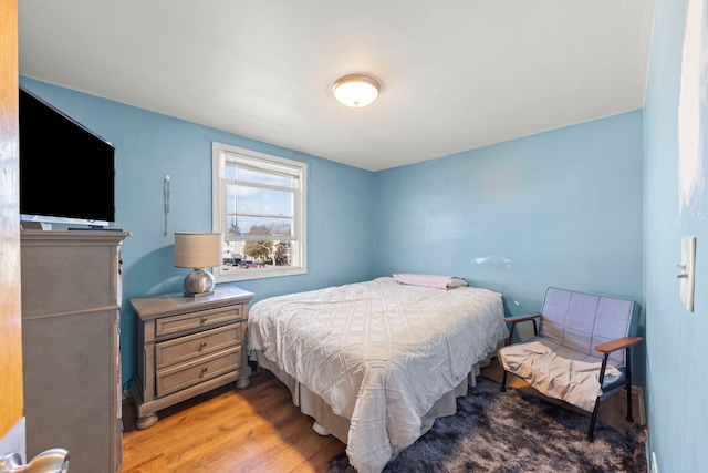 bedroom with light wood finished floors