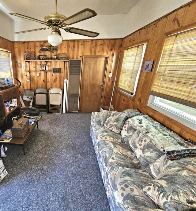 319 S Reed St, Joliet, IL 60436 - carpeted living area featuring plenty of natural light, wooden walls, and a ceiling fan