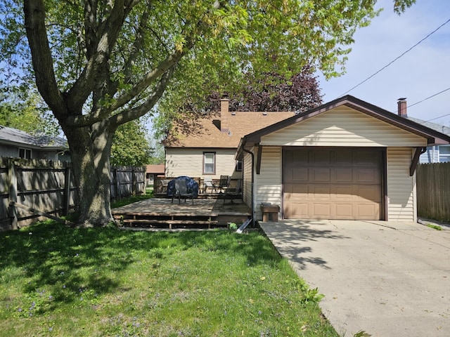 319 S Reed St, Joliet, IL 60436 - view of front facade with a detached garage, concrete driveway, a wooden deck, and a chimney