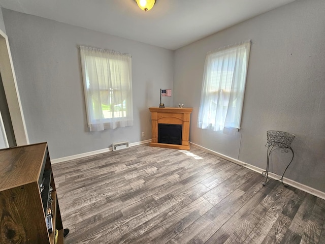 319 S Reed St, Joliet, IL 60436 - living room featuring wood finished floors, a fireplace, and baseboards