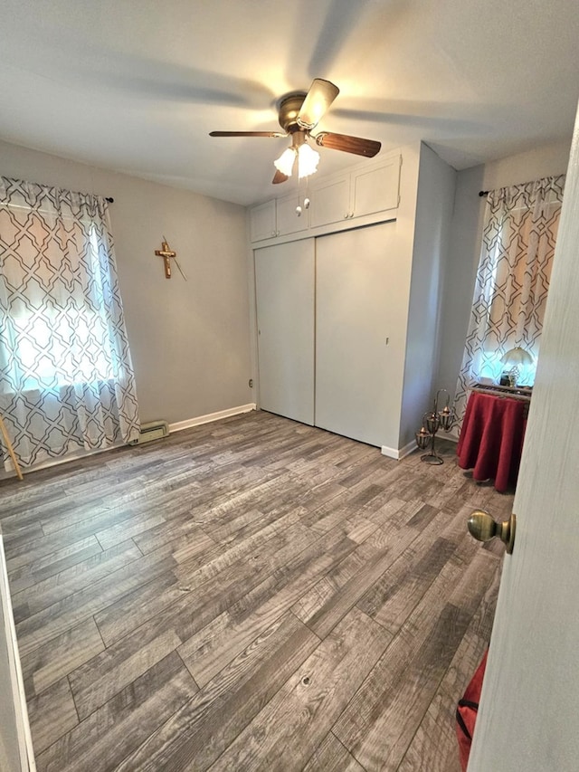 319 S Reed St, Joliet, IL 60436 - unfurnished bedroom featuring wood finished floors, ceiling fan, baseboards, and a closet
