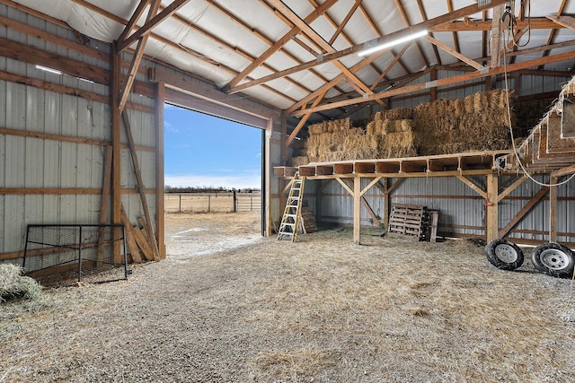 view of horse barn with a rural view