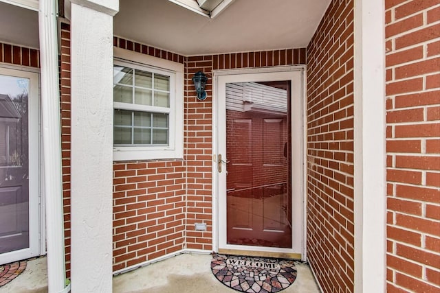 property entrance with brick siding