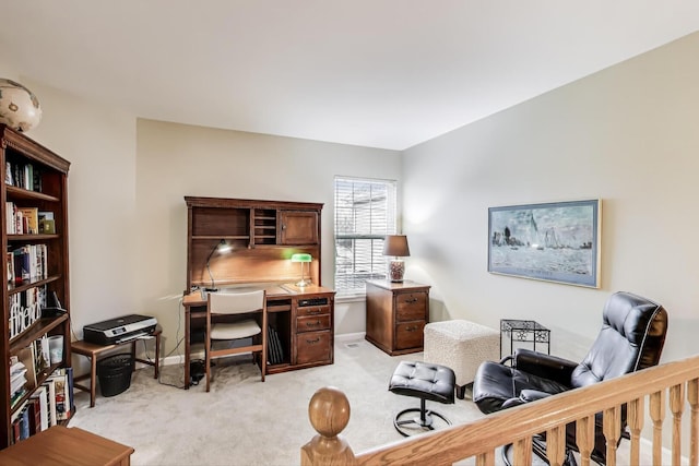 office featuring baseboards and light carpet