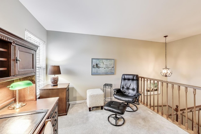 living area featuring baseboards, light carpet, an inviting chandelier, and an upstairs landing