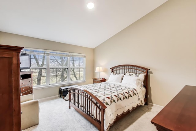 bedroom featuring lofted ceiling, carpet flooring, and baseboards