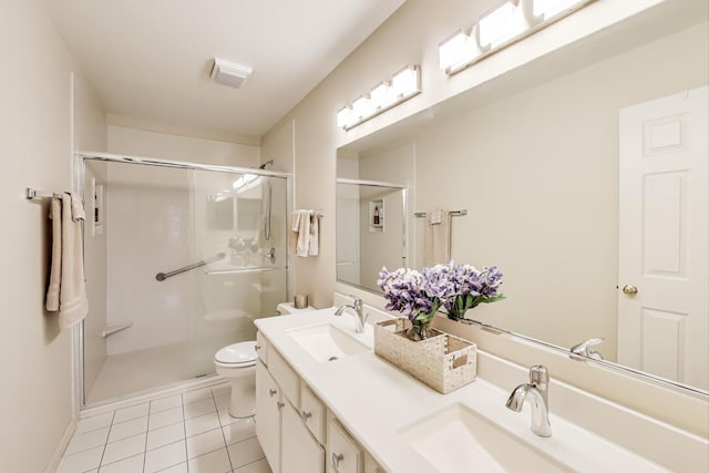 full bathroom featuring a sink, toilet, a stall shower, and tile patterned flooring