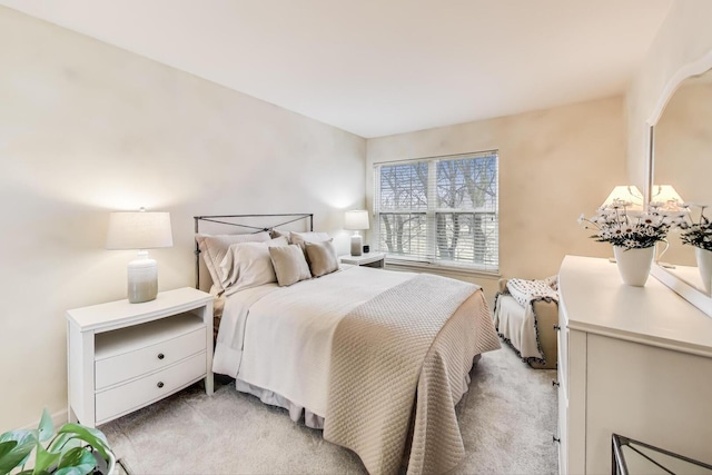 bedroom featuring light colored carpet