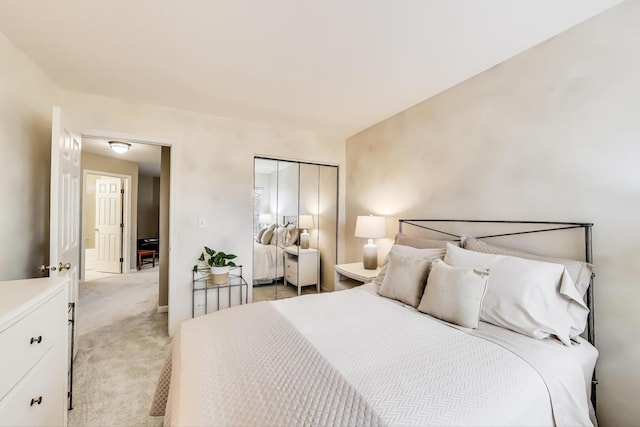 bedroom with light carpet and a closet