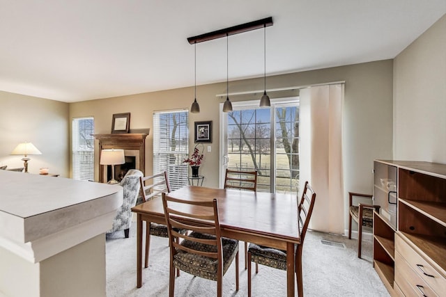 dining area with visible vents and light carpet