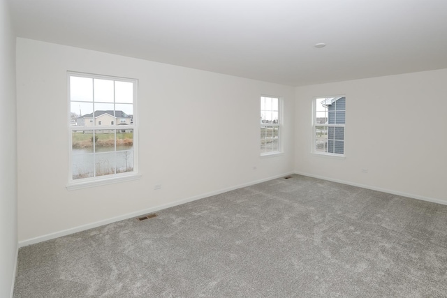 unfurnished room featuring light colored carpet