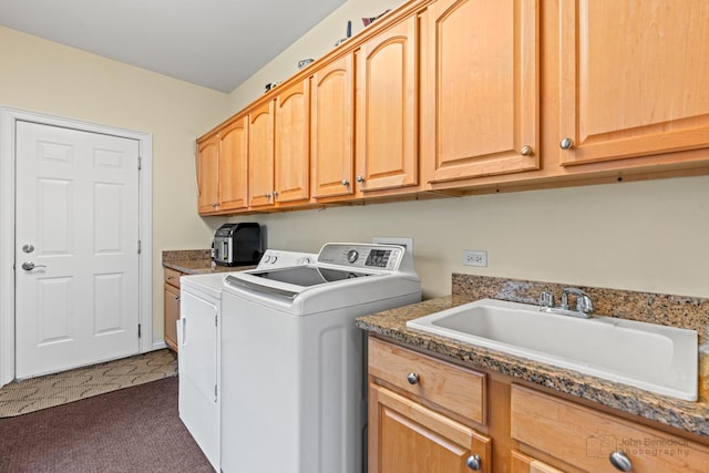 clothes washing area featuring a sink, cabinet space, and washer and dryer