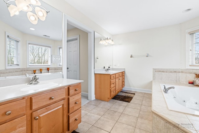 full bathroom with two vanities, tile patterned flooring, a sink, and a wealth of natural light