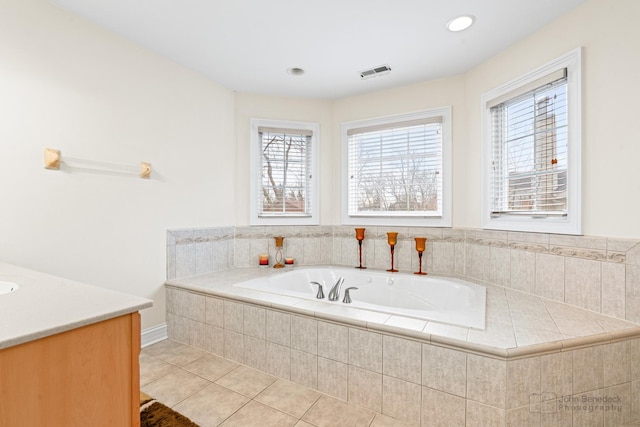 bathroom with a bath, vanity, visible vents, and tile patterned floors